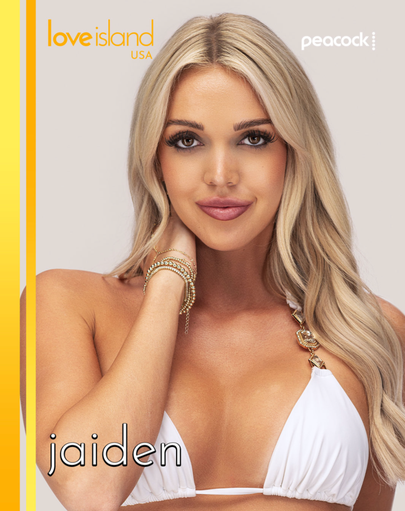 A blonde woman with long hair wearing a white bikini top and jewelry, posing against a yellow and white background with the "Love Island USA" and "Peacock" logos.