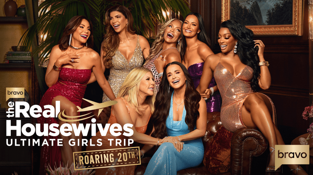 A group of glamorously dressed women posing together in an opulent setting, with the Bravo logo and text "The Real Housewives Ultimate Girls Trip Roaring 20th" visible.