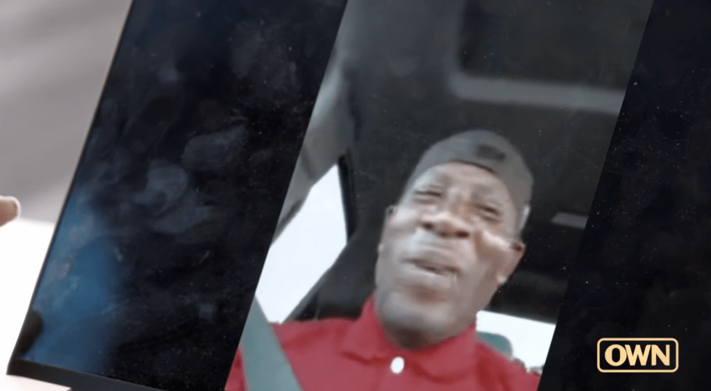 A person in a red shirt appears to be speaking or reacting to something off-camera. The OWN logo is visible in the bottom right corner.