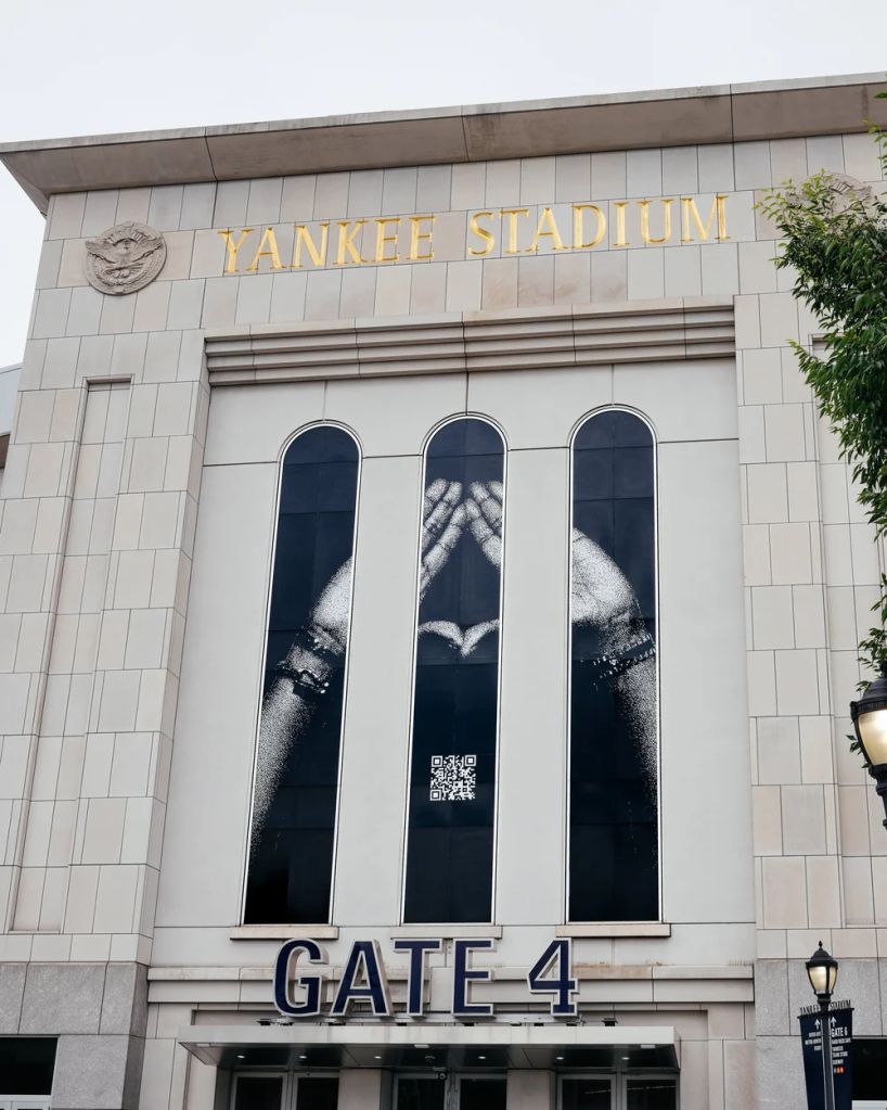 Exterior of Yankee Stadium with the stadium name and Gate 4 entrance visible.