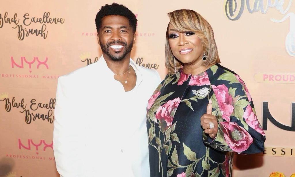 Two smiling people posing at a Black Excellence Brunch event, with the NYX Professional Makeup logo visible.