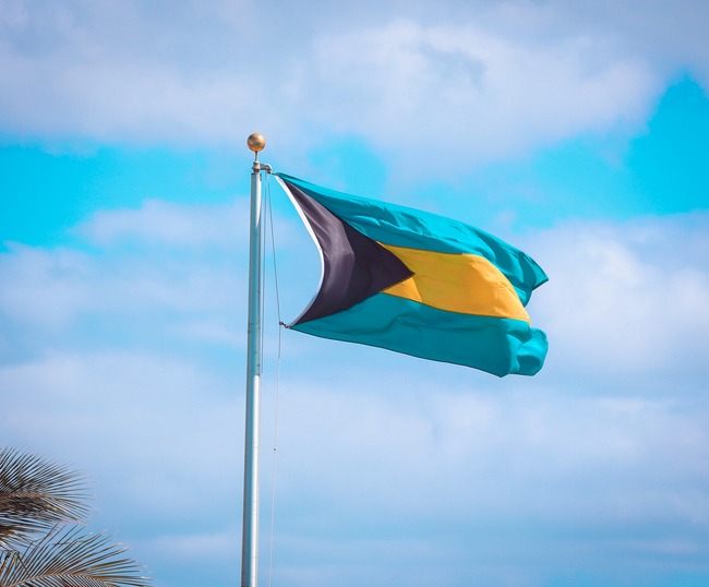 Waving flag of The Bahamas in beautiful sky. The Bahamas flag for independence day.