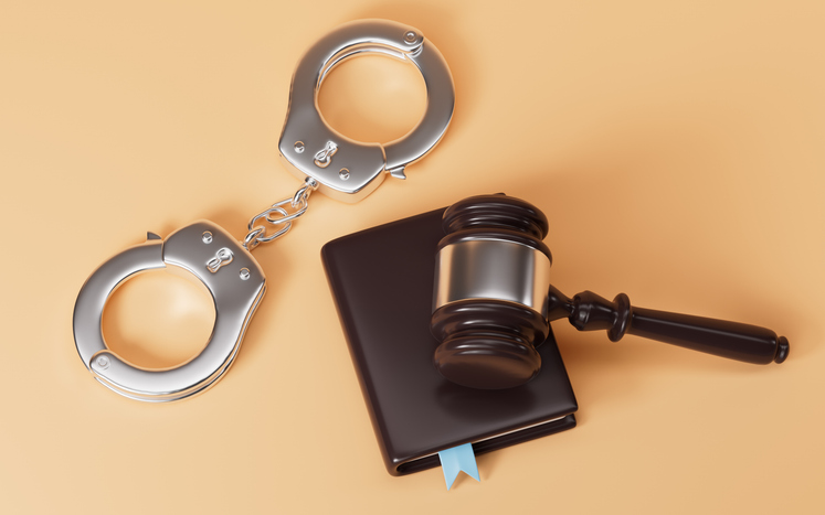 Golden judge gavel and police handcuffs. Symbolizing justice and legal proceedings. 3d rendering.