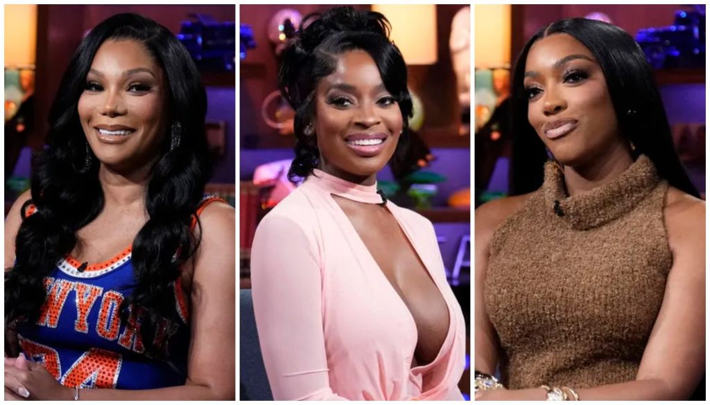 Three smiling Black women in glamorous outfits: a woman in a blue and orange "New York" jersey, a woman in a pink dress, and a woman in a brown fuzzy sweater.