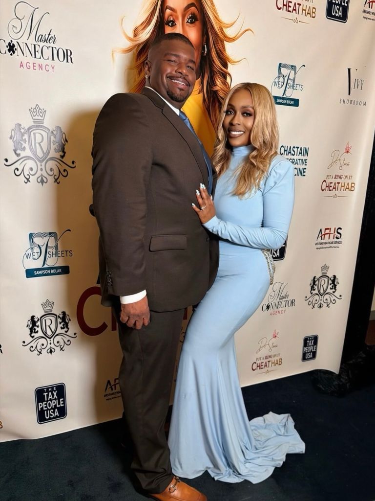 A smiling couple posing in front of a backdrop with the "Master Connector Agency" logo and other branding.