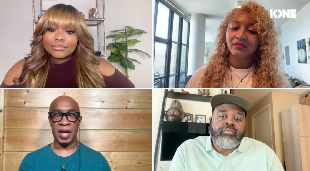 Four people in a video call, including two women with long curly hair and two men, one bald and one with a beard, discussing or presenting something.