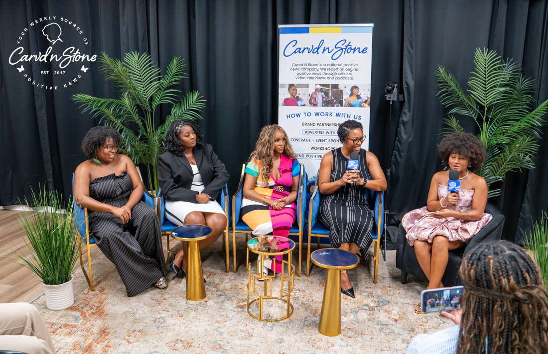 A group of five women sitting on chairs in front of a backdrop with the "Cardi n Stone" logo, discussing or presenting at an event.